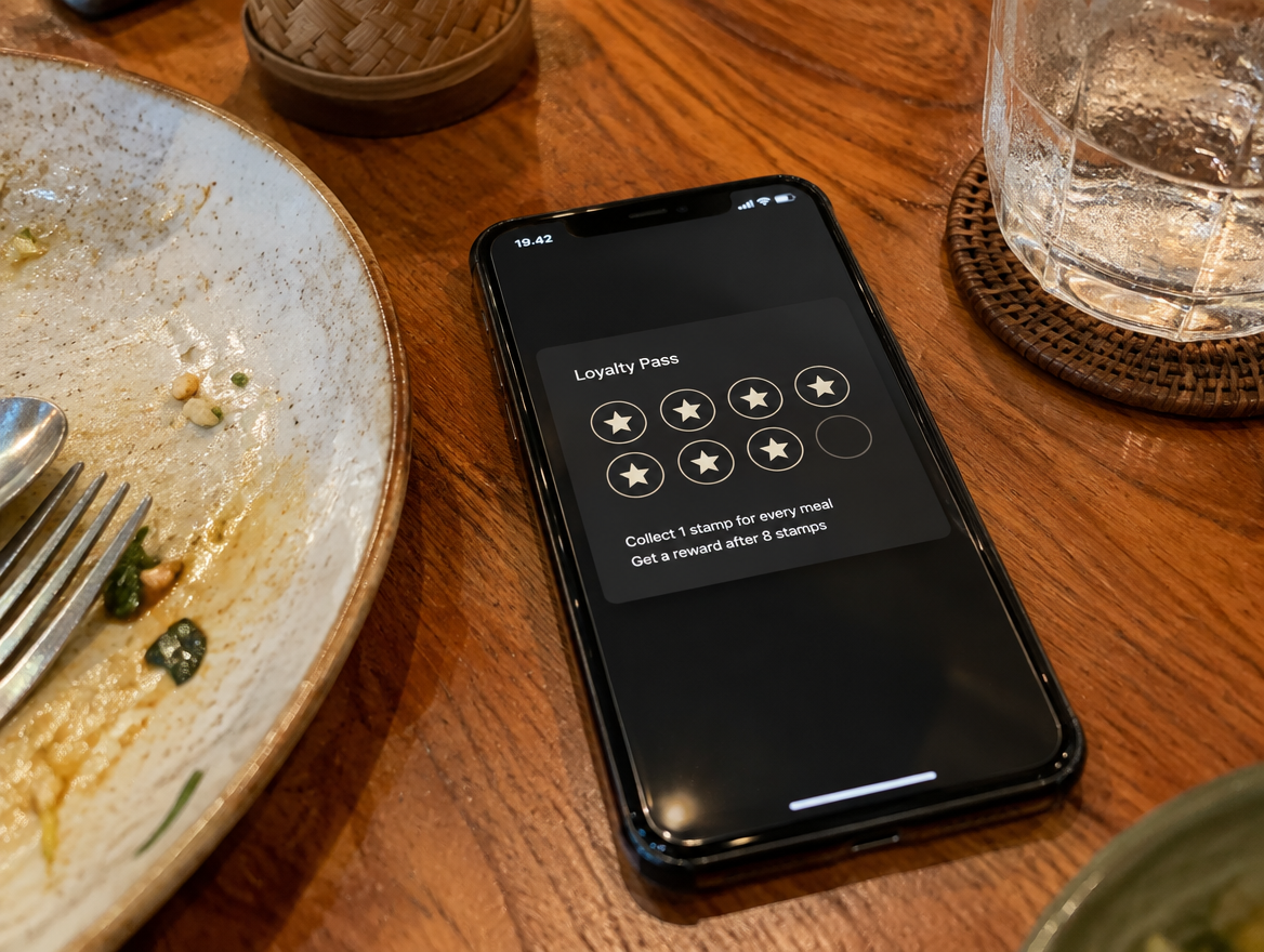 Loyalty pass on a phone at an Indonesian restaurant table